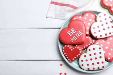 Photo of Heart shaped cookies on white wooden table, flat lay with space for text. Valentine's day treat