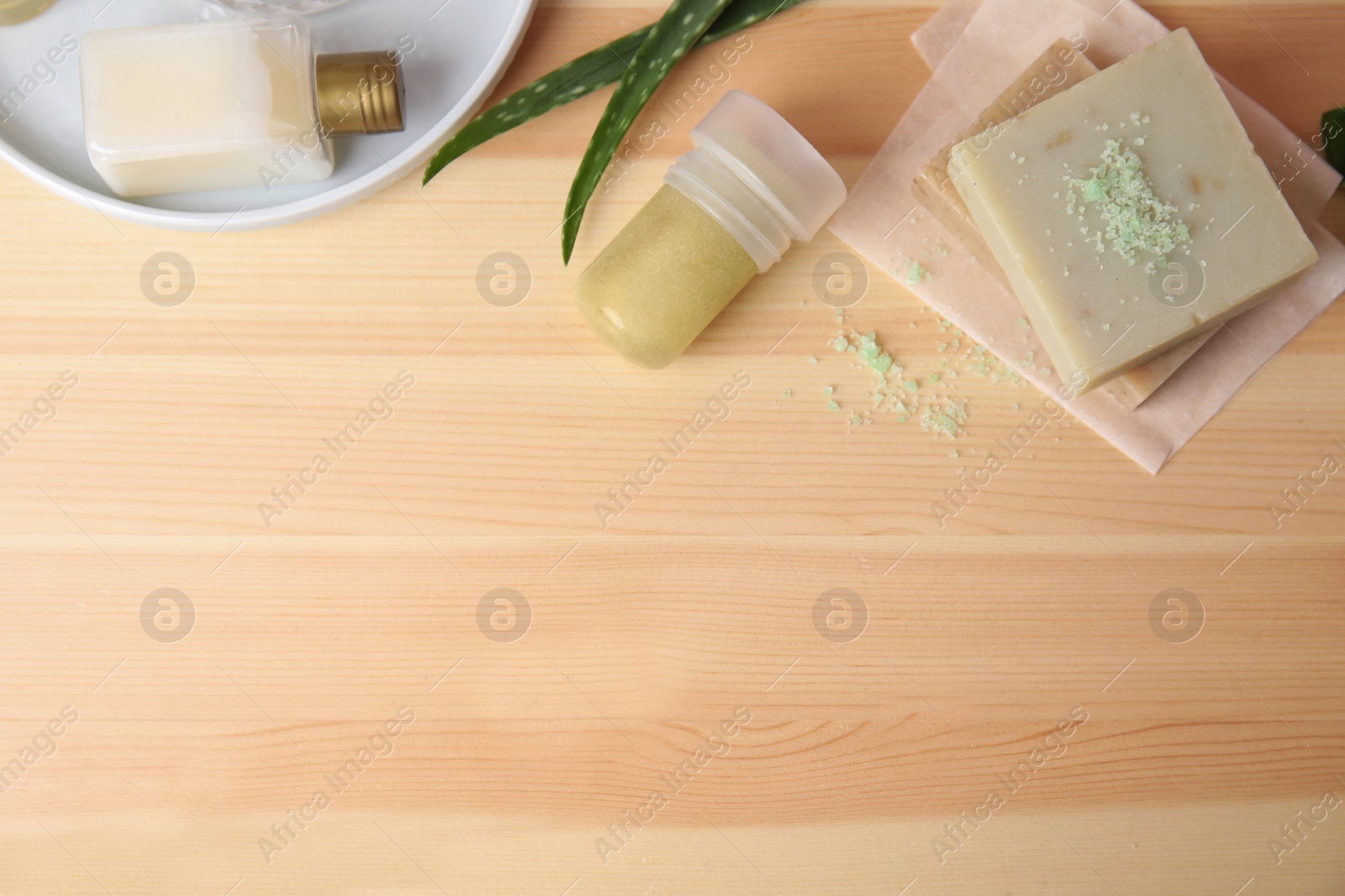 Photo of Flat lay composition with natural crystal alum deodorant and space for text on wooden table