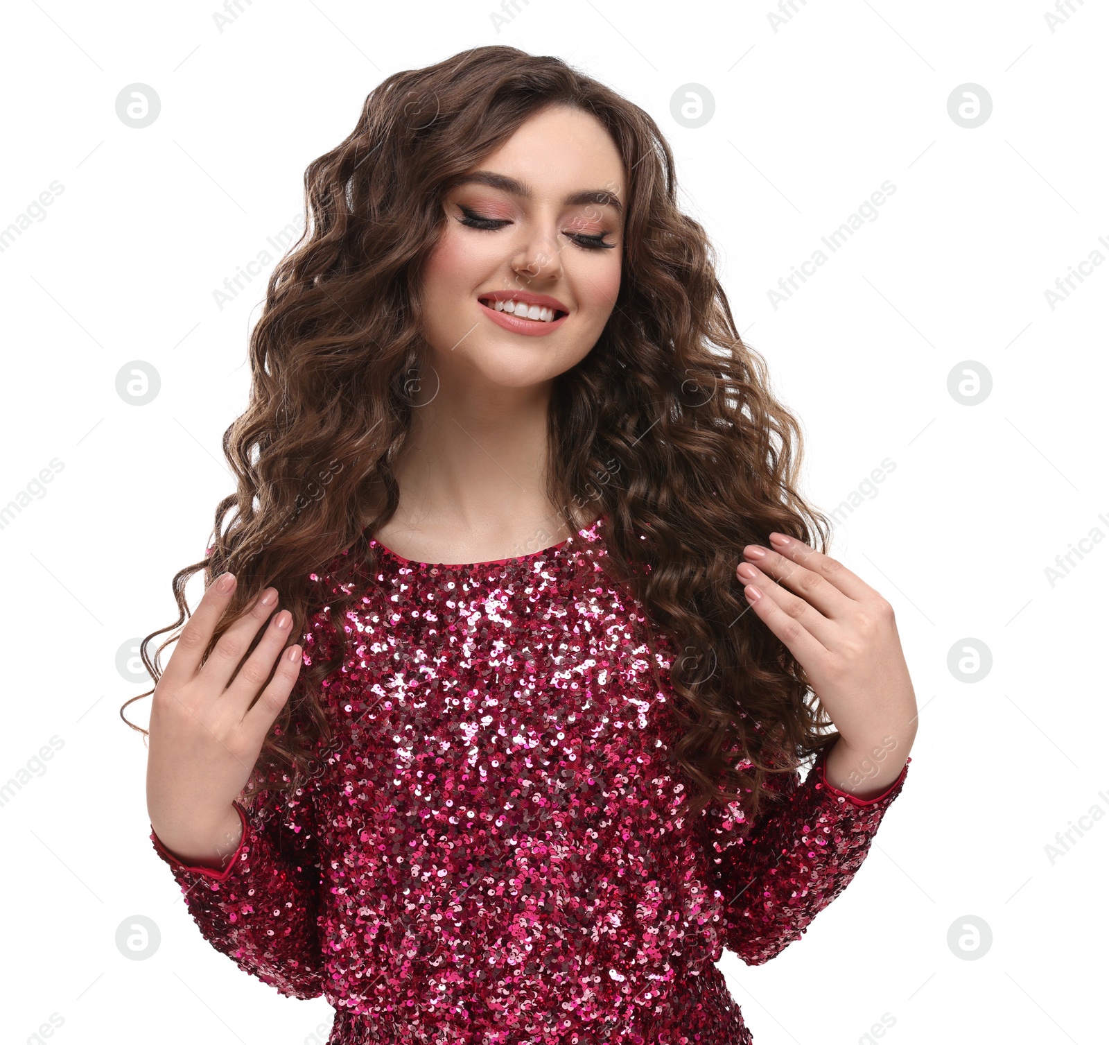 Photo of Beautiful young woman with long curly brown hair in pink sequin dress on white background