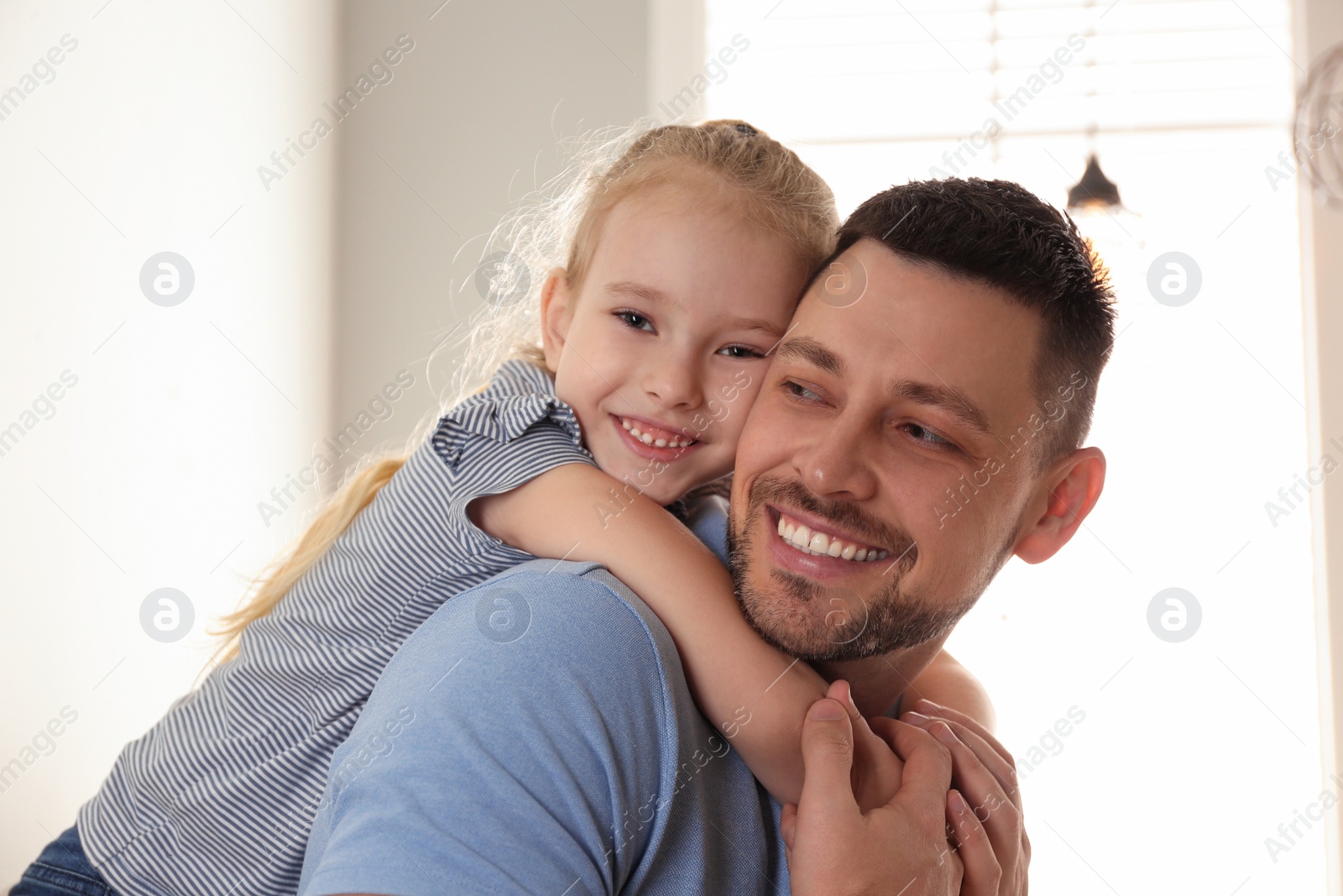 Photo of Dad and daughter spending time together at home. Happy Father's Day