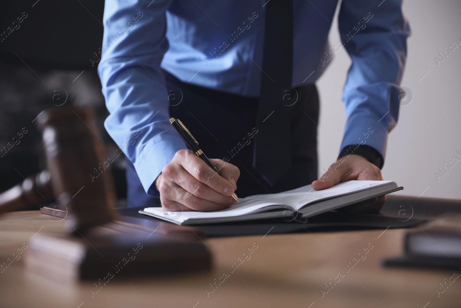 Photo of Male lawyer working at table in office, closeup