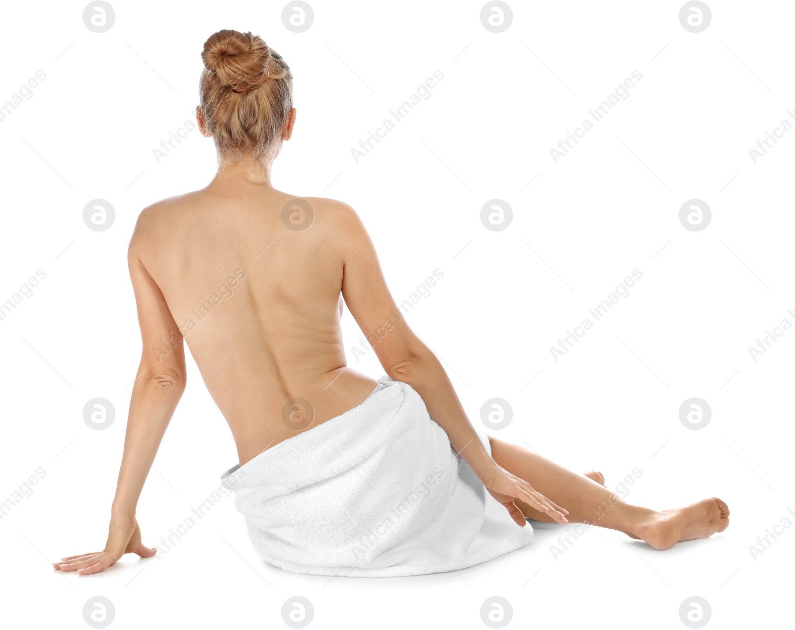 Photo of Young woman with soft towel sitting on white background