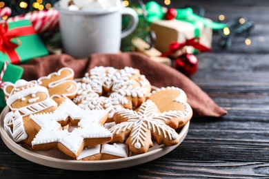 Photo of Delicious Christmas cookies on black wooden table table