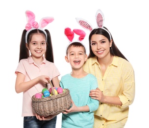 Photo of Cute family in bunny ears headbands with basket of Easter eggs on white background
