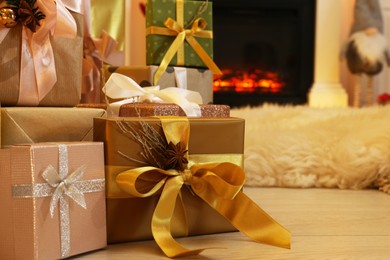 Christmas celebration. Many gift boxes on floor at home, closeup. Space for text