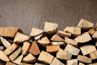 Photo of Cut firewood on brown background. Heating in winter