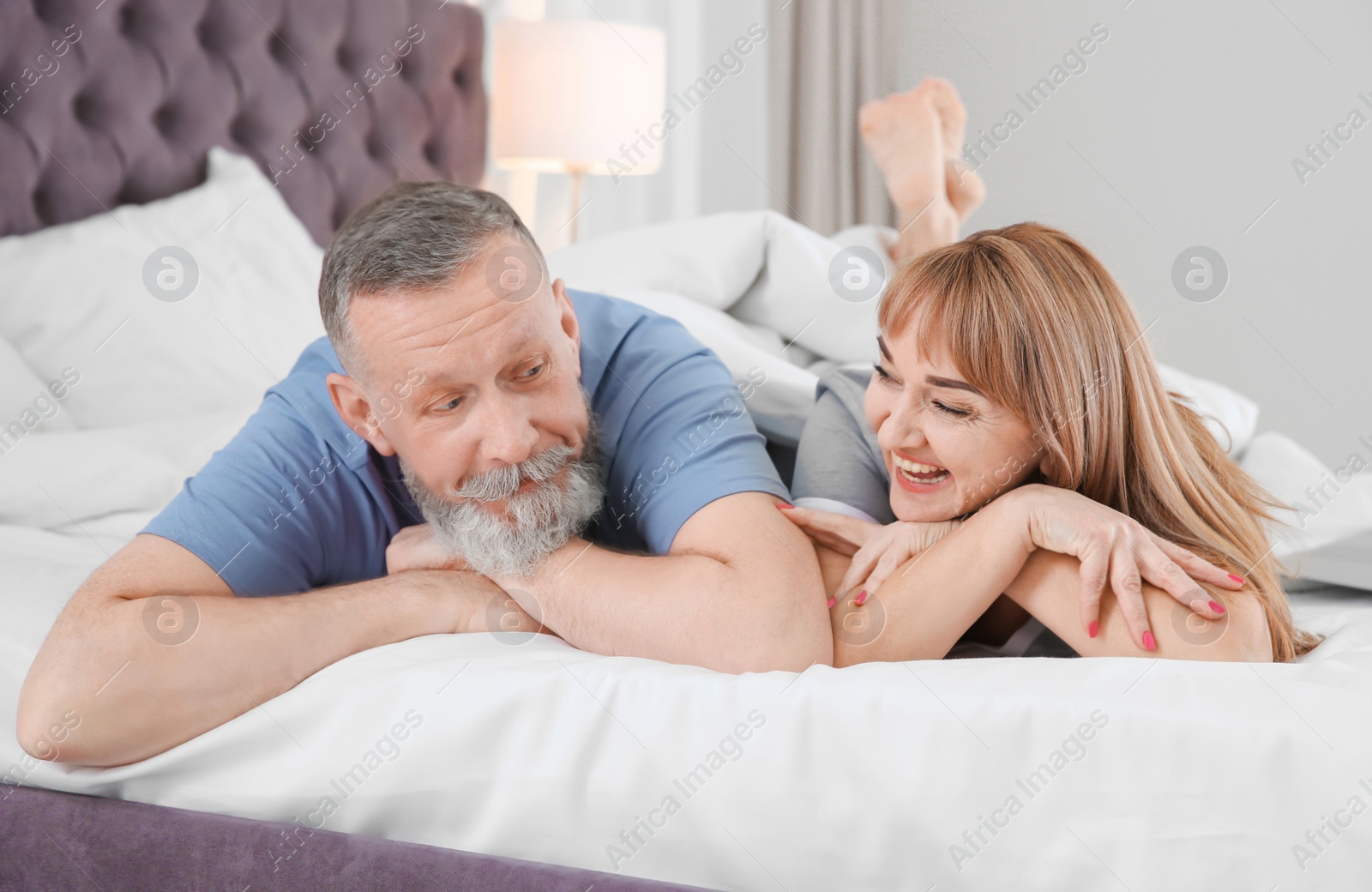 Photo of Mature couple together in bed at home