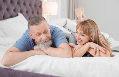 Photo of Mature couple together in bed at home