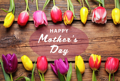 Image of Flat lay composition with beautiful tulips and phrase HAPPY MOTHER'S DAY on wooden background