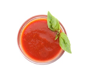 Photo of Bowl of tasty tomato sauce with basil isolated on white, top view