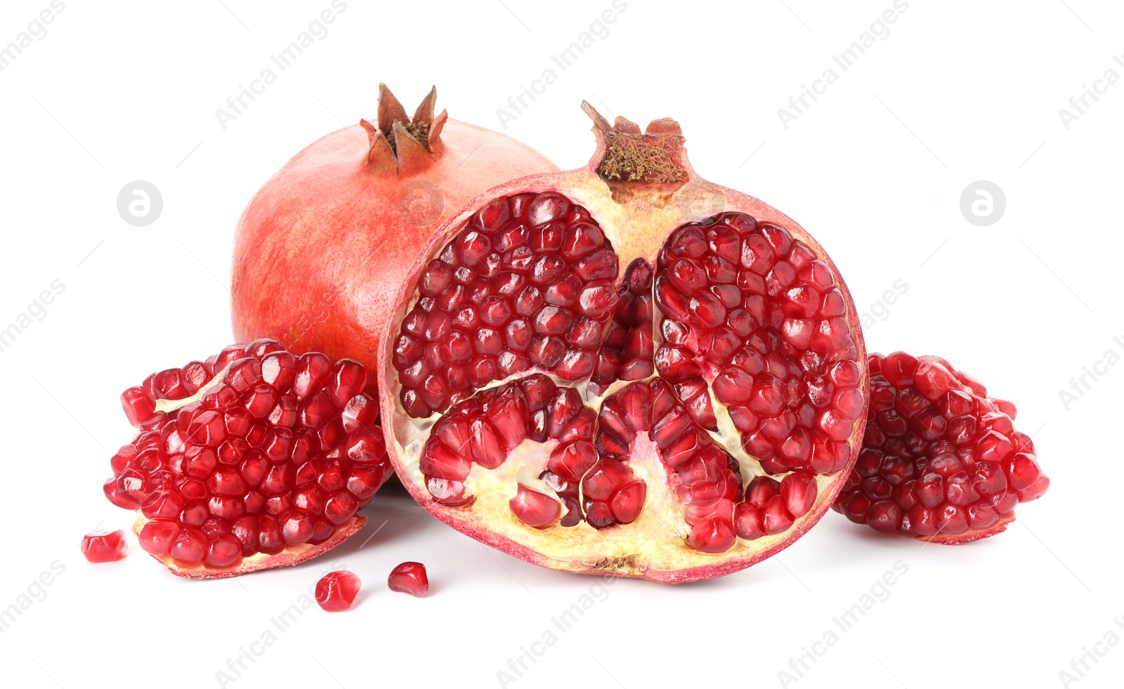 Photo of Cut and whole pomegranates isolated on white