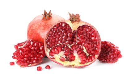 Photo of Cut and whole pomegranates isolated on white