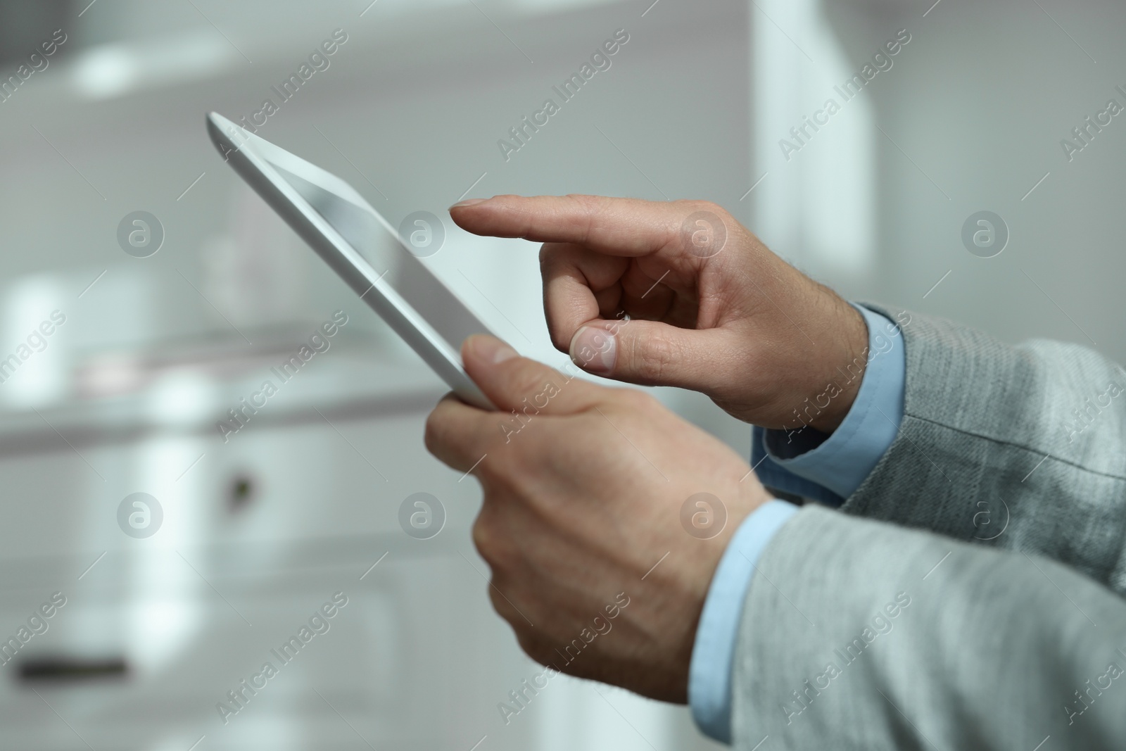 Photo of Closeup view of man using new tablet indoors