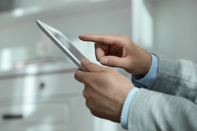 Closeup view of man using new tablet indoors