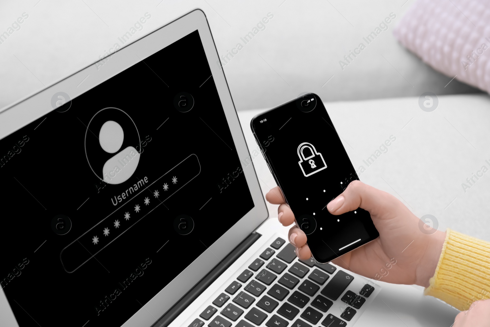 Photo of Woman unlocking smartphone with blocked screen near laptop indoors, closeup