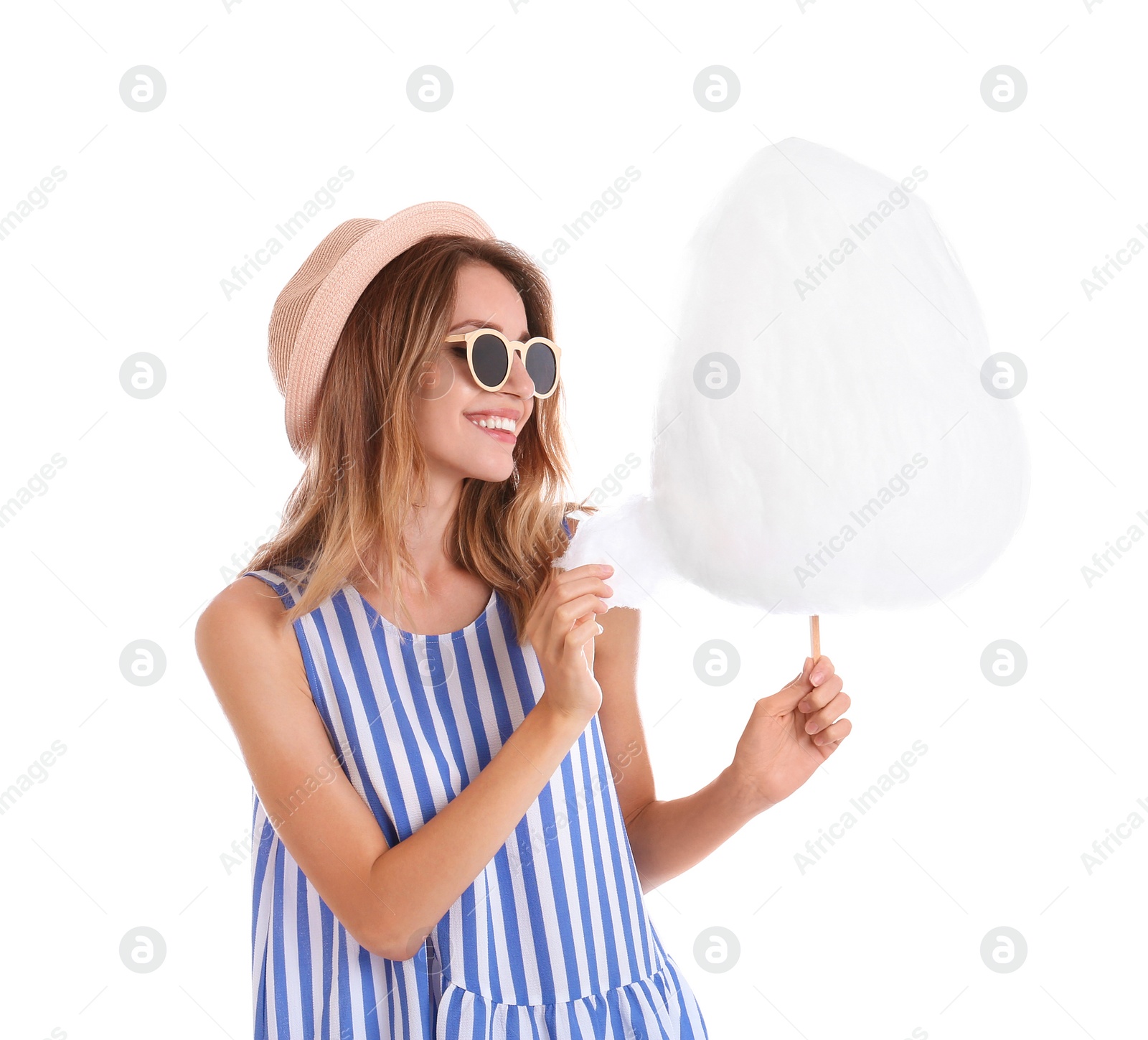 Photo of Happy young woman with cotton candy on white background