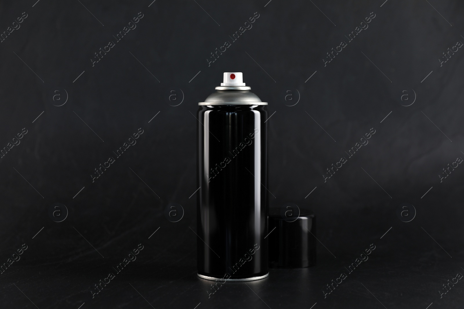 Photo of Can of spray paint on black background