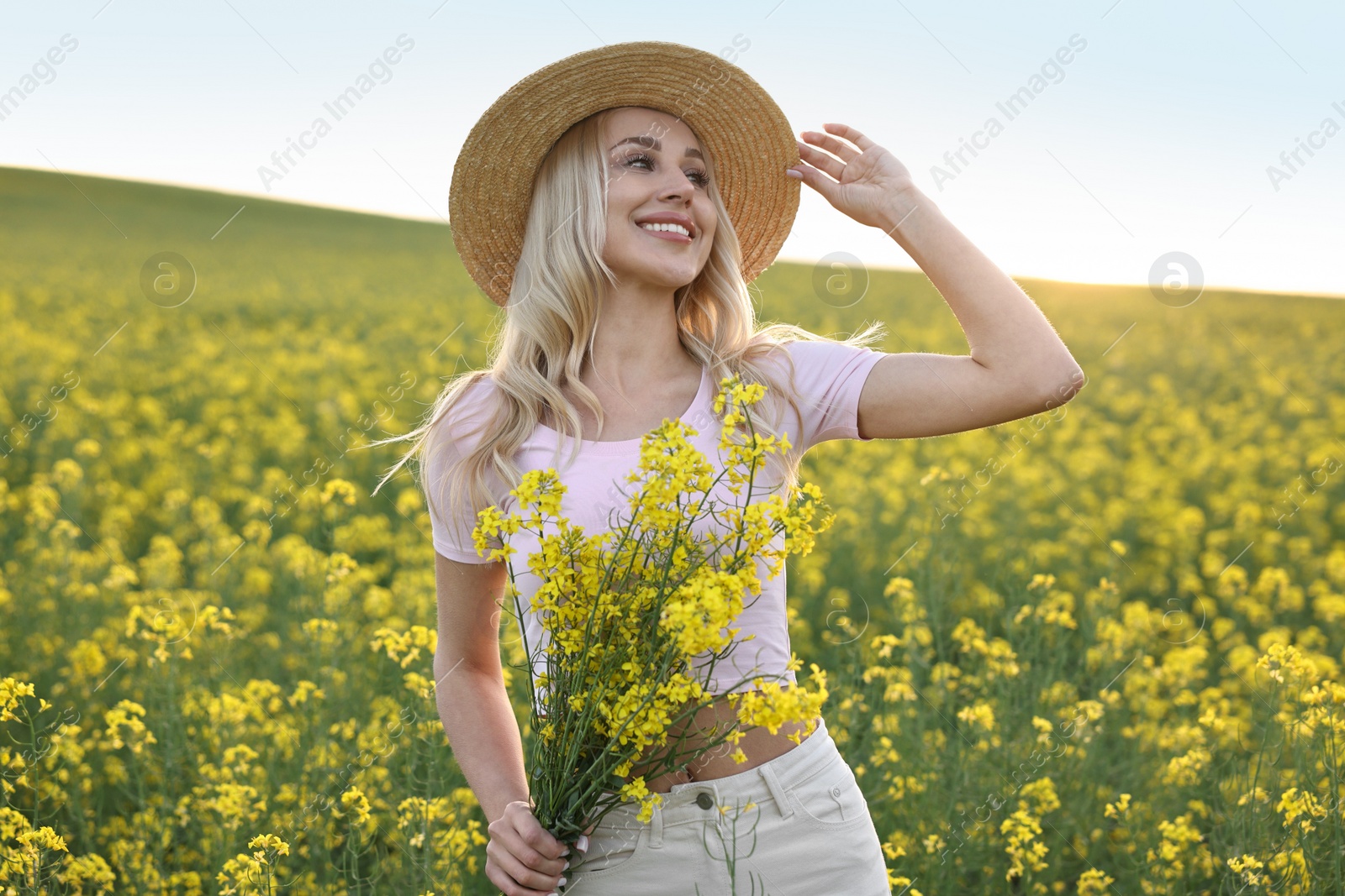 Photo of Portrait of happy young woman in field on spring day