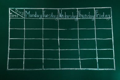 Photo of Weekly school timetable drawn on green chalkboard