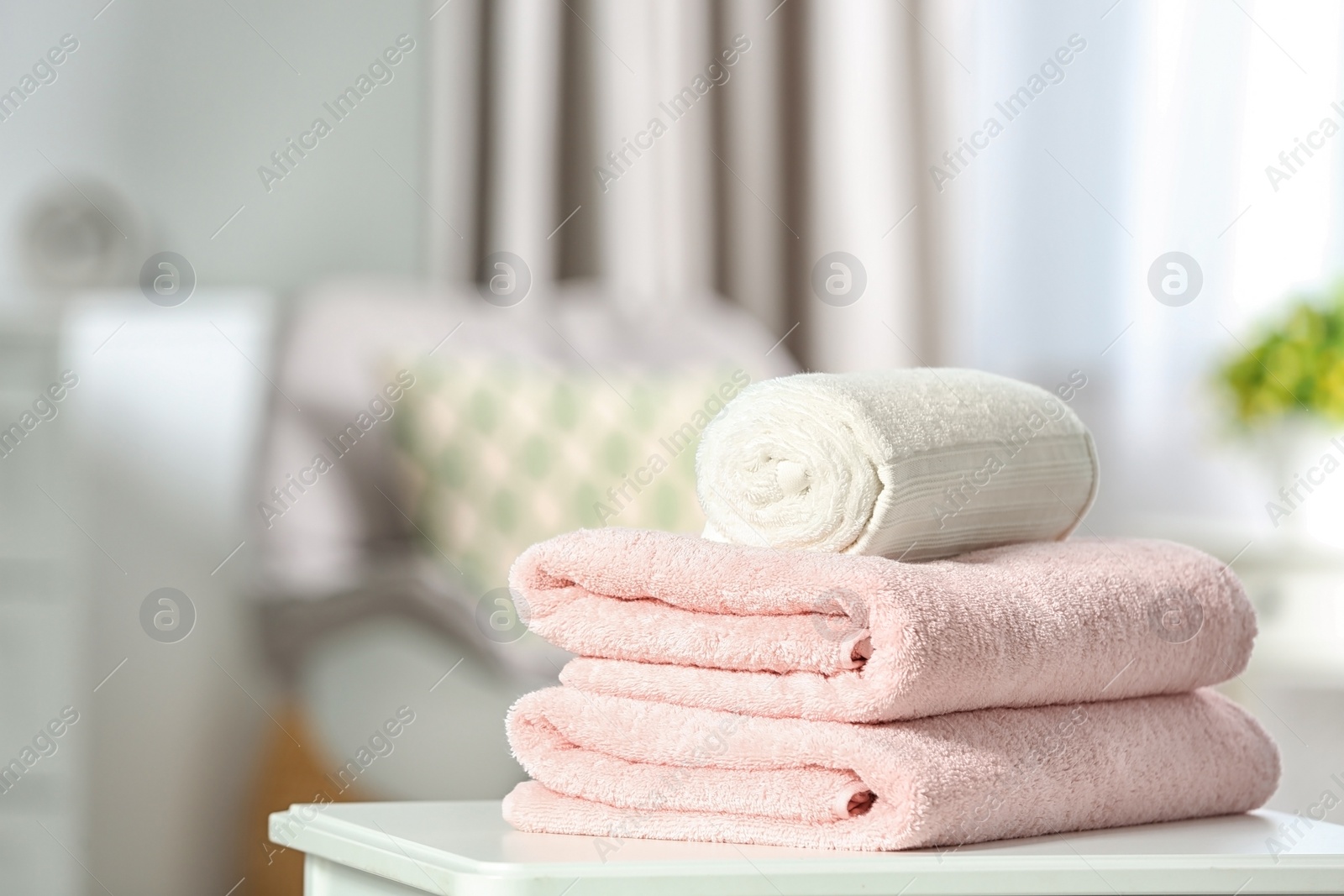 Photo of Clean soft terry towels on table indoors. Space for text