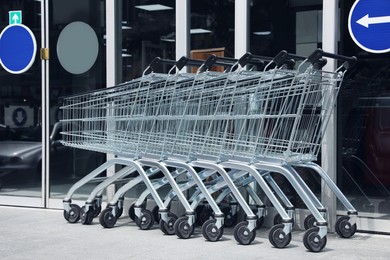 Photo of Row of shopping carts near store outdoors