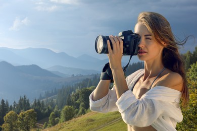 Photographer taking picture of beautiful mountains with professional camera