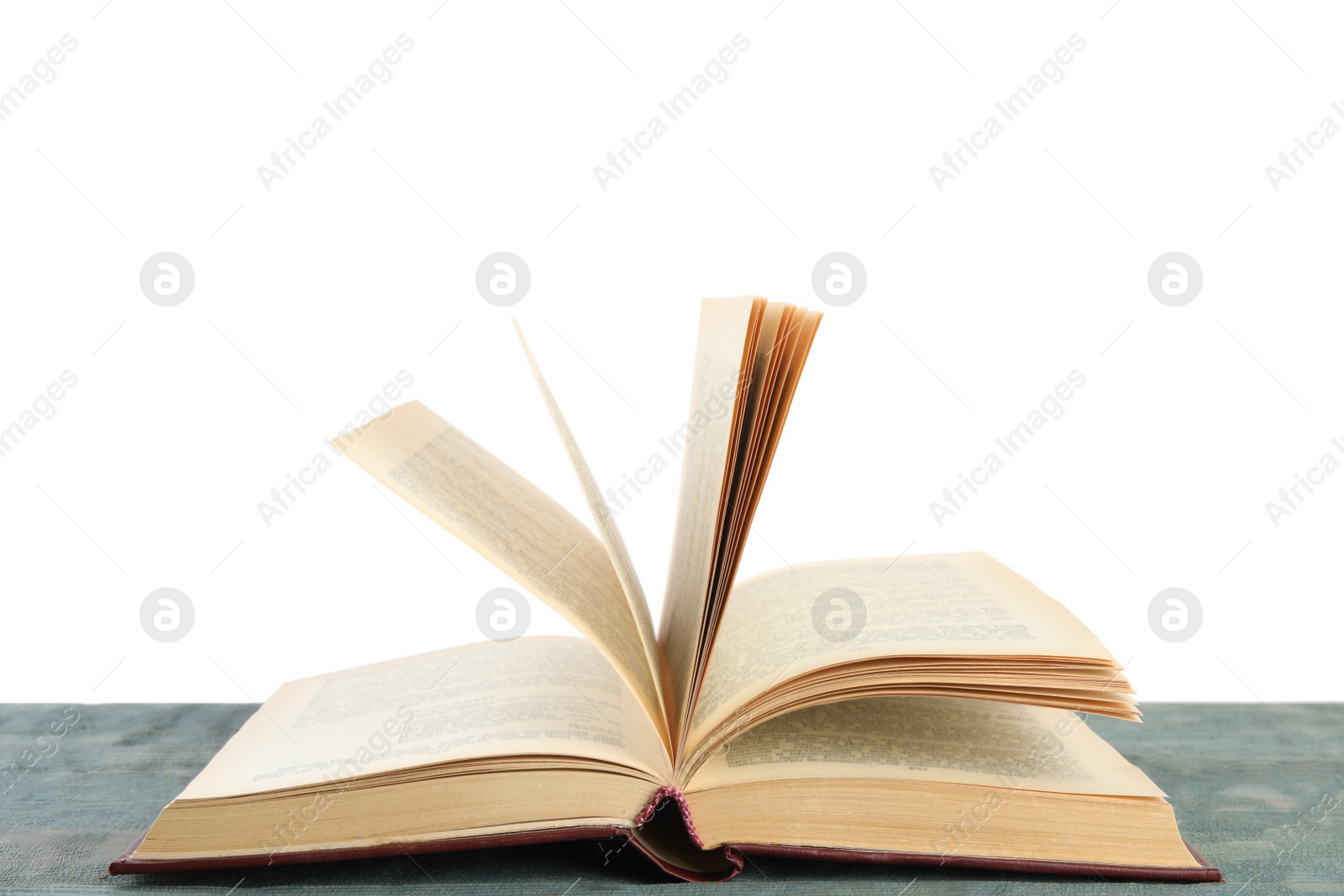 Photo of Open old hardcover book on wooden table