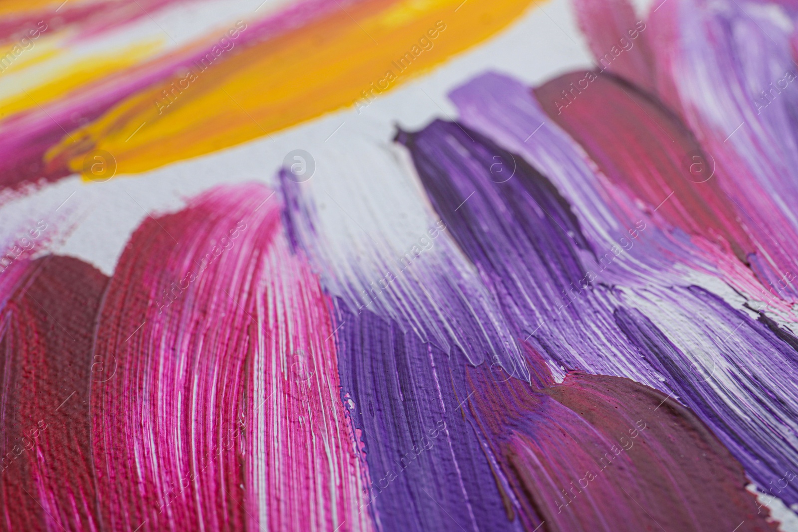 Photo of Strokes of colorful oil paints on white canvas, closeup