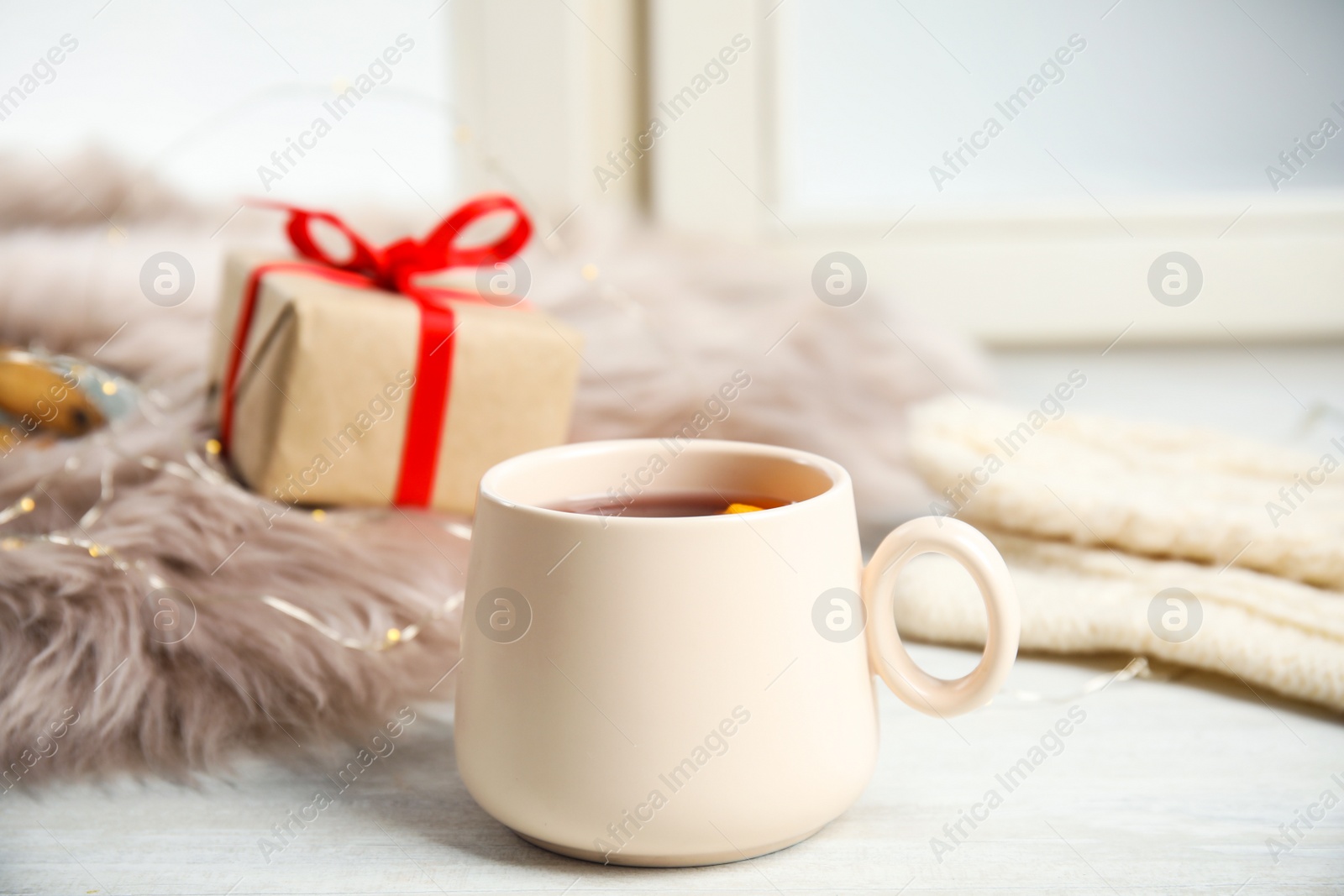 Photo of Cup of hot winter drink on window sill