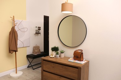 Modern hallway interior with stylish furniture and mirror