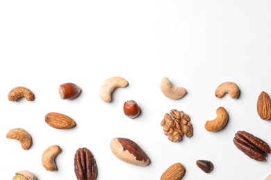 Composition with organic mixed nuts on white background, top view. Space for text