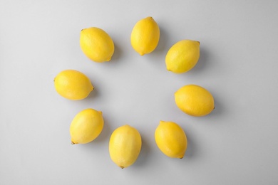 Photo of Tasty fresh lemons on white background, top view