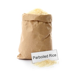 Photo of Paper bag with uncooked parboiled rice and card on white background