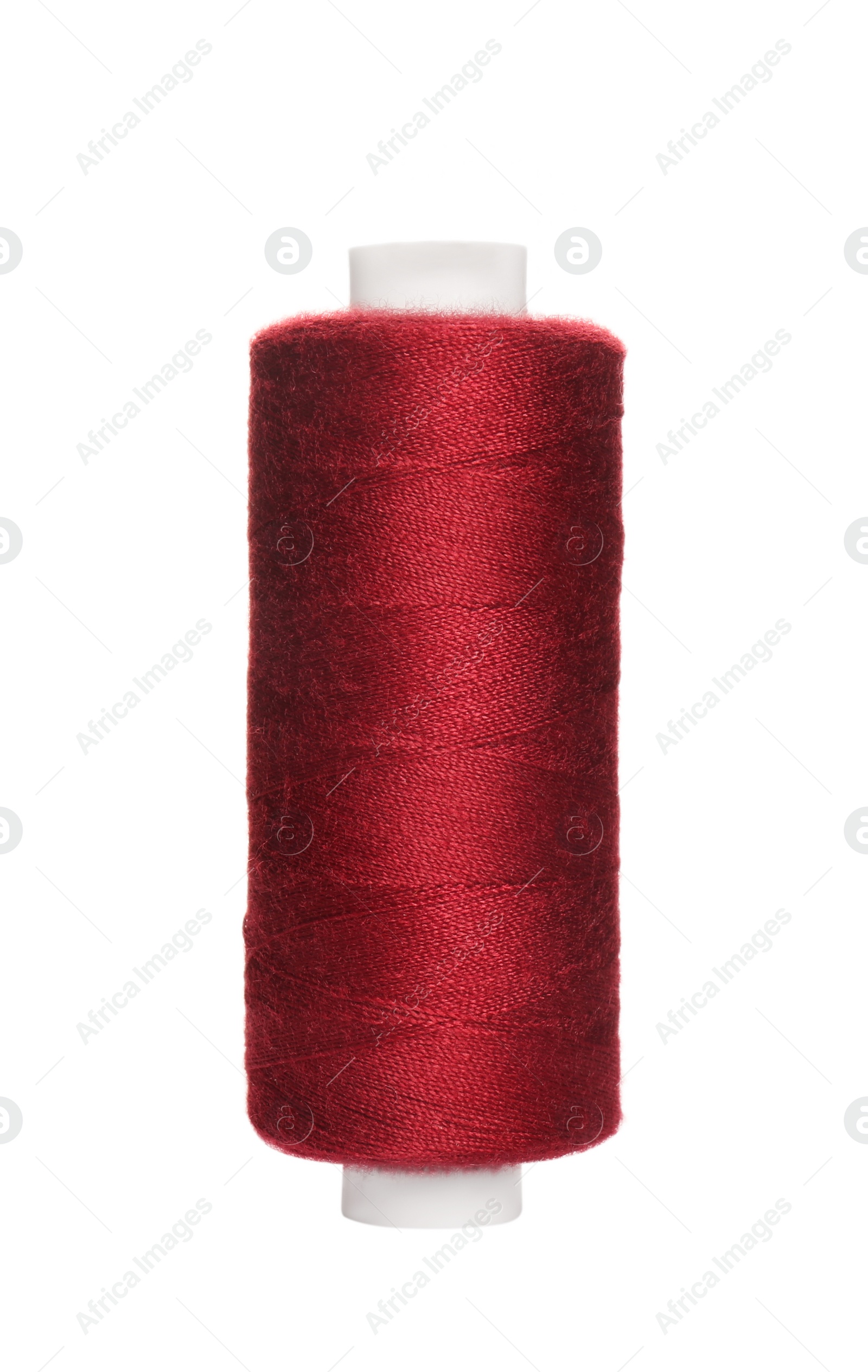 Photo of Spool of burgundy sewing thread isolated on white