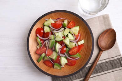 Photo of Flat lay composition with delicious fresh cucumber tomato salad served on table