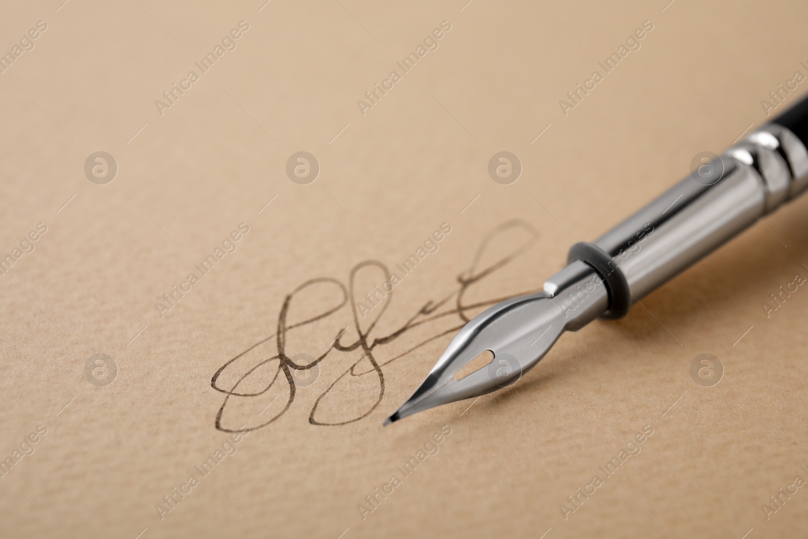 Photo of Signature and fountain pen on sheet of paper, closeup. Space for text