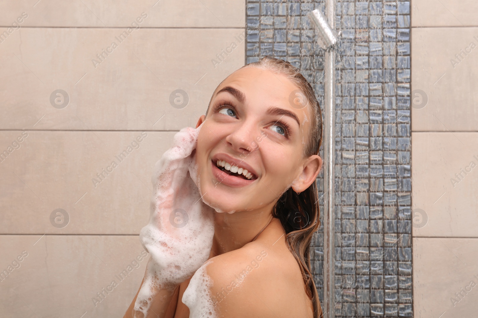 Photo of Beautiful young woman taking shower at home