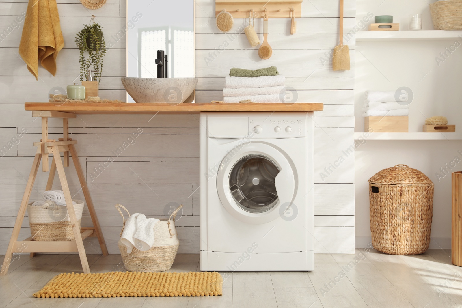 Photo of Stylish bathroom interior with modern washing machine