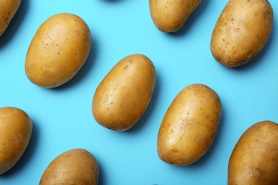 Flat lay composition with fresh ripe organic potatoes on color background