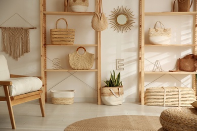 Photo of Stylish woman's bags on shelves in boutique