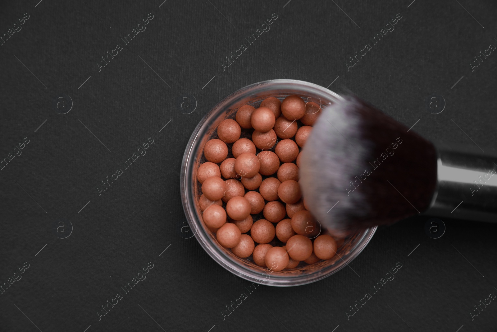 Photo of Face powder and makeup brush on black background, flat lay. Space for text