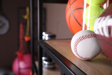 Photo of Different sport balls on shelf indoors, closeup. Space for text