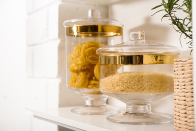 Products in modern kitchen glass containers on shelving unit