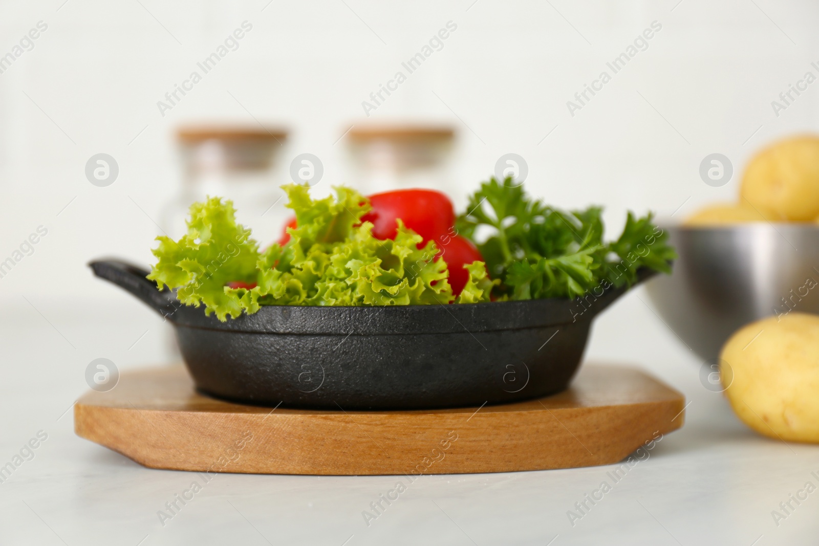 Photo of Portioned frying pan with products on table