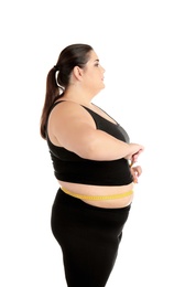 Overweight woman with measuring tape on white background