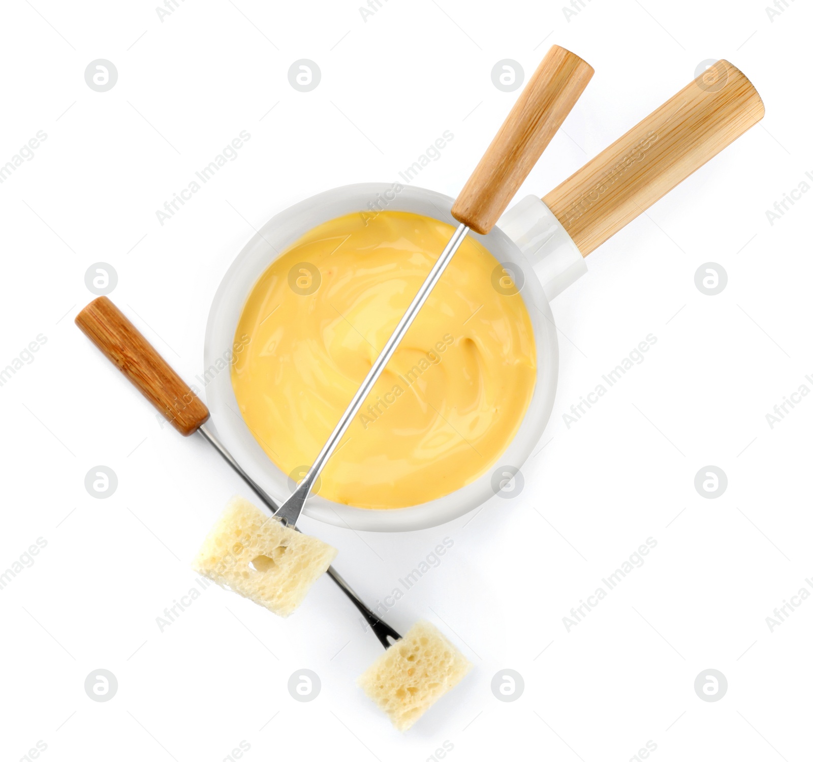 Photo of Pot of tasty cheese fondue and forks isolated on white, top view