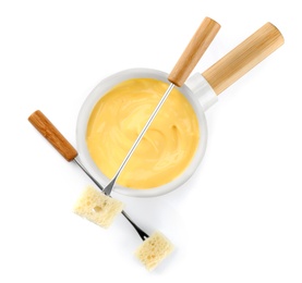 Pot of tasty cheese fondue and forks isolated on white, top view