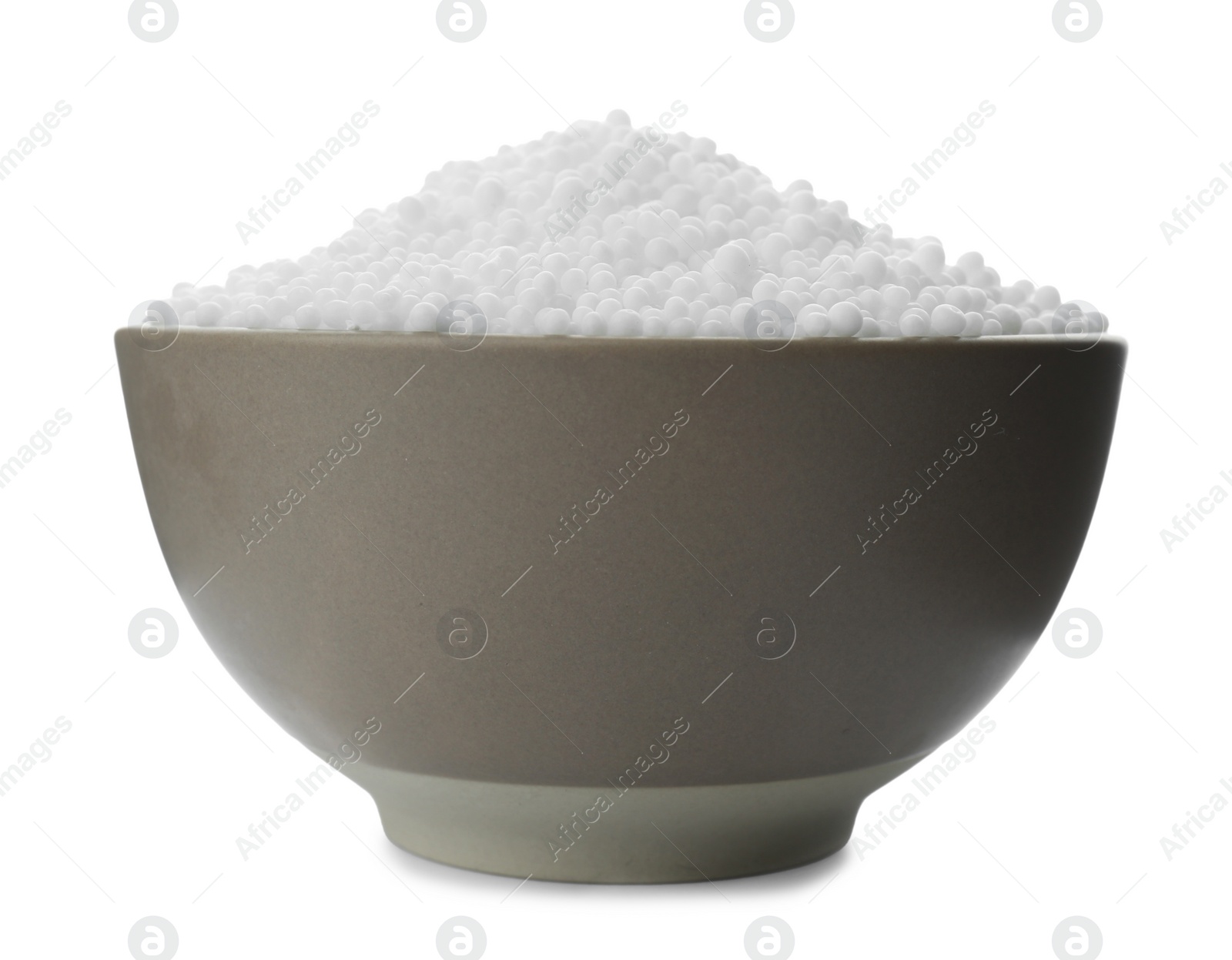 Photo of Pellets of ammonium nitrate in bowl isolated on white. Mineral fertilizer