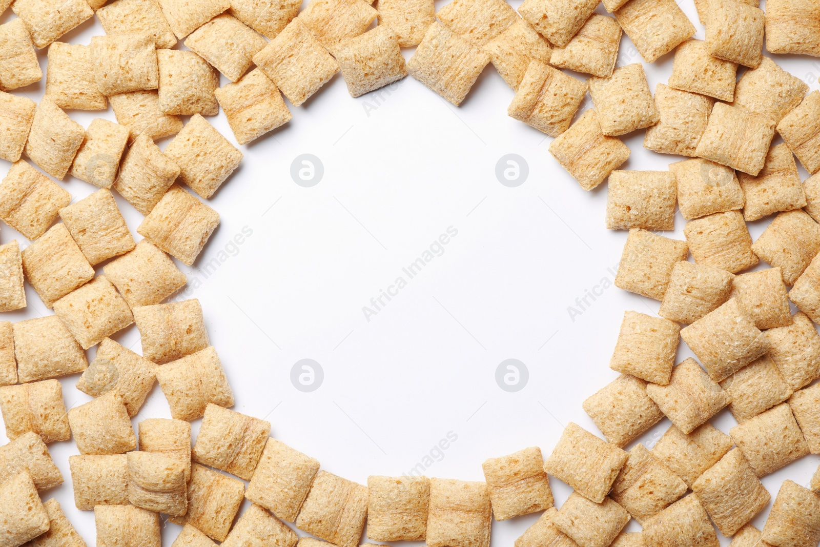 Photo of Frame made with delicious corn pads on white background, top view. Space for text