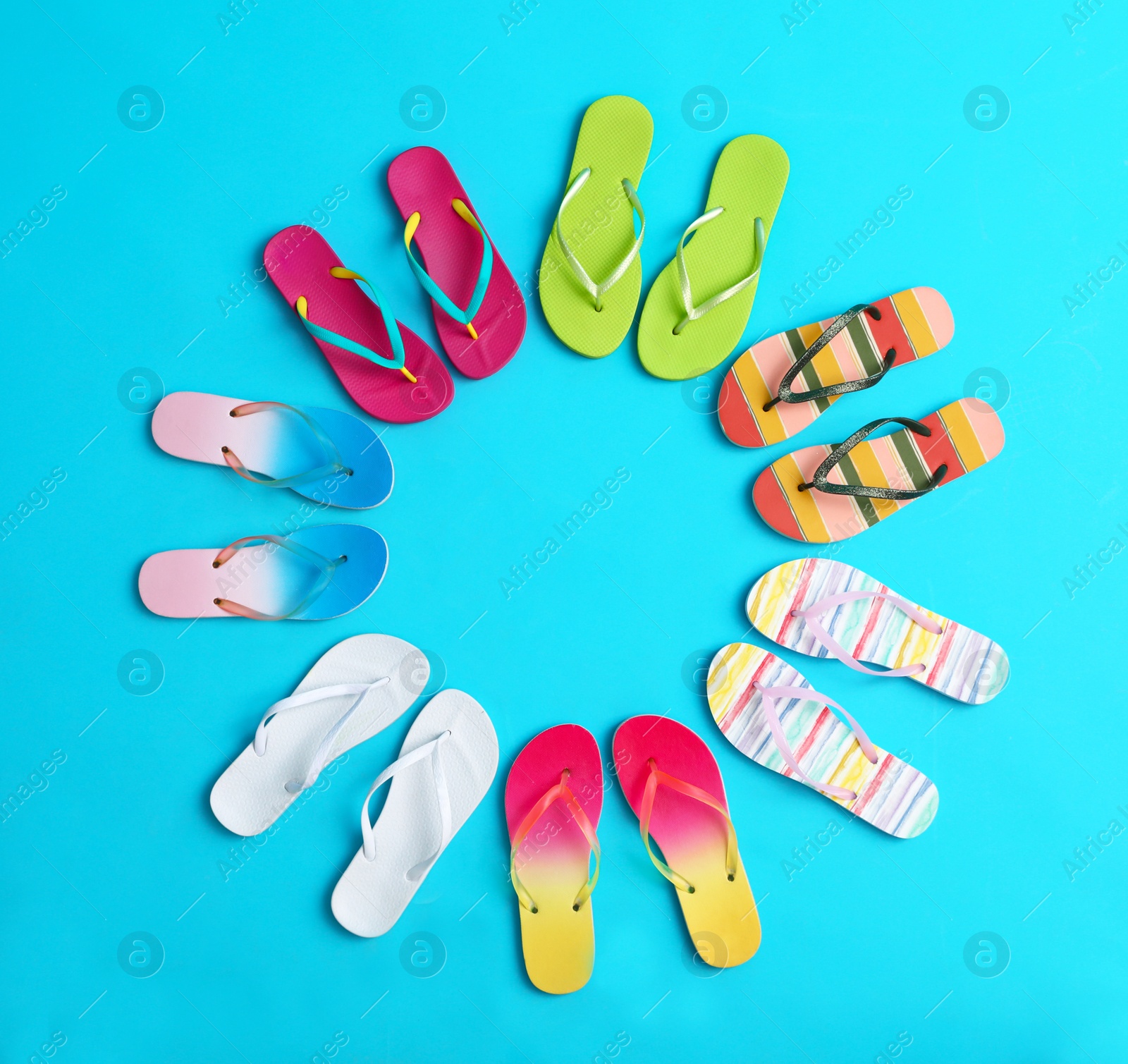 Photo of Flat lay composition with different flip flops on blue background, space for text. Summer beach accessories